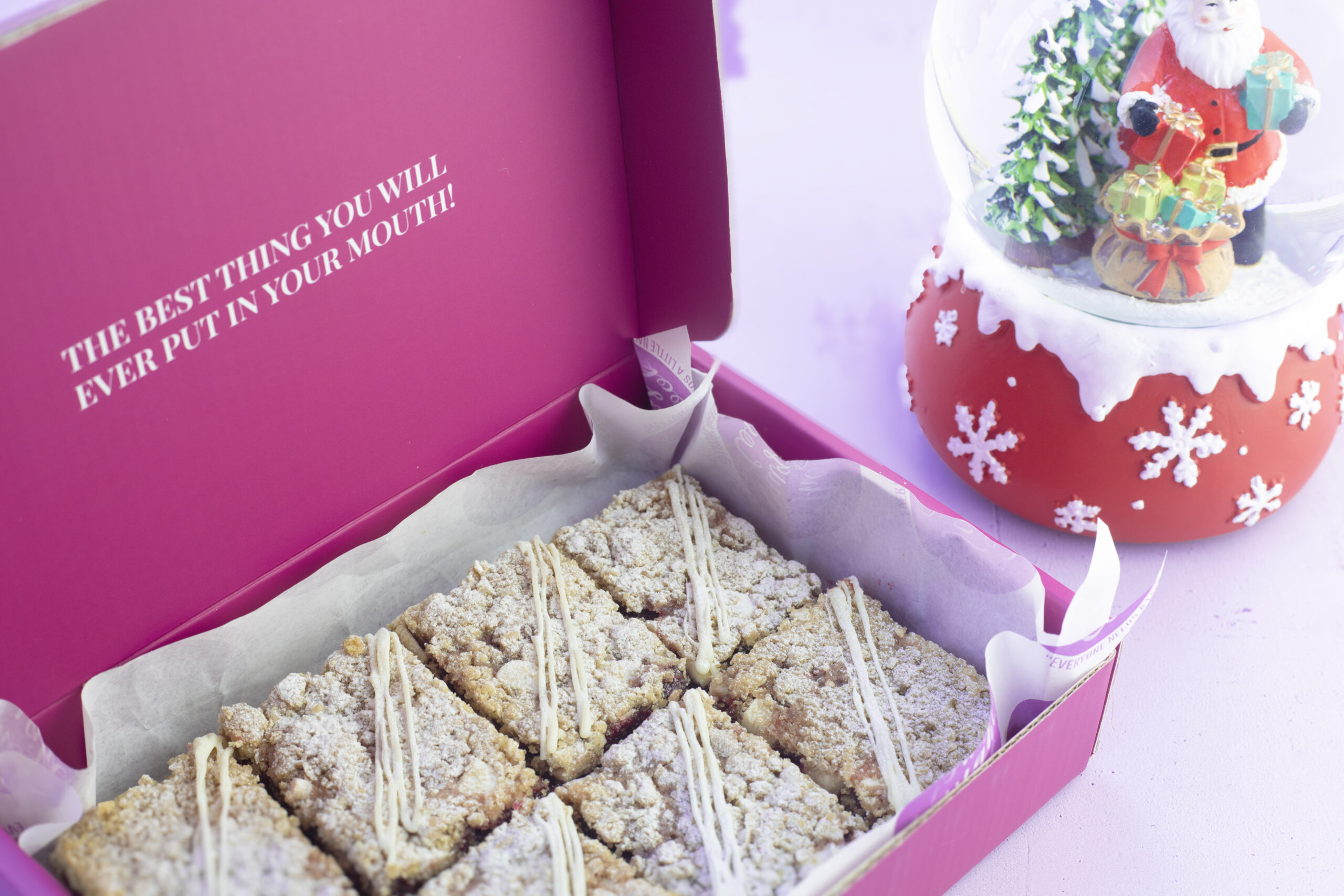 Close-up cranberry and white chocolate crumble with caramelised chocolate drizzle