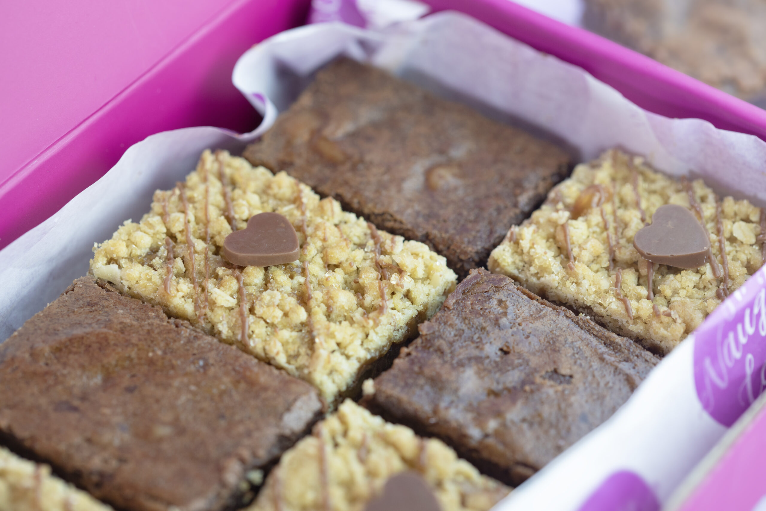 Premium packaged box of salted fudge brownies and triple chocolate crumbles in close up