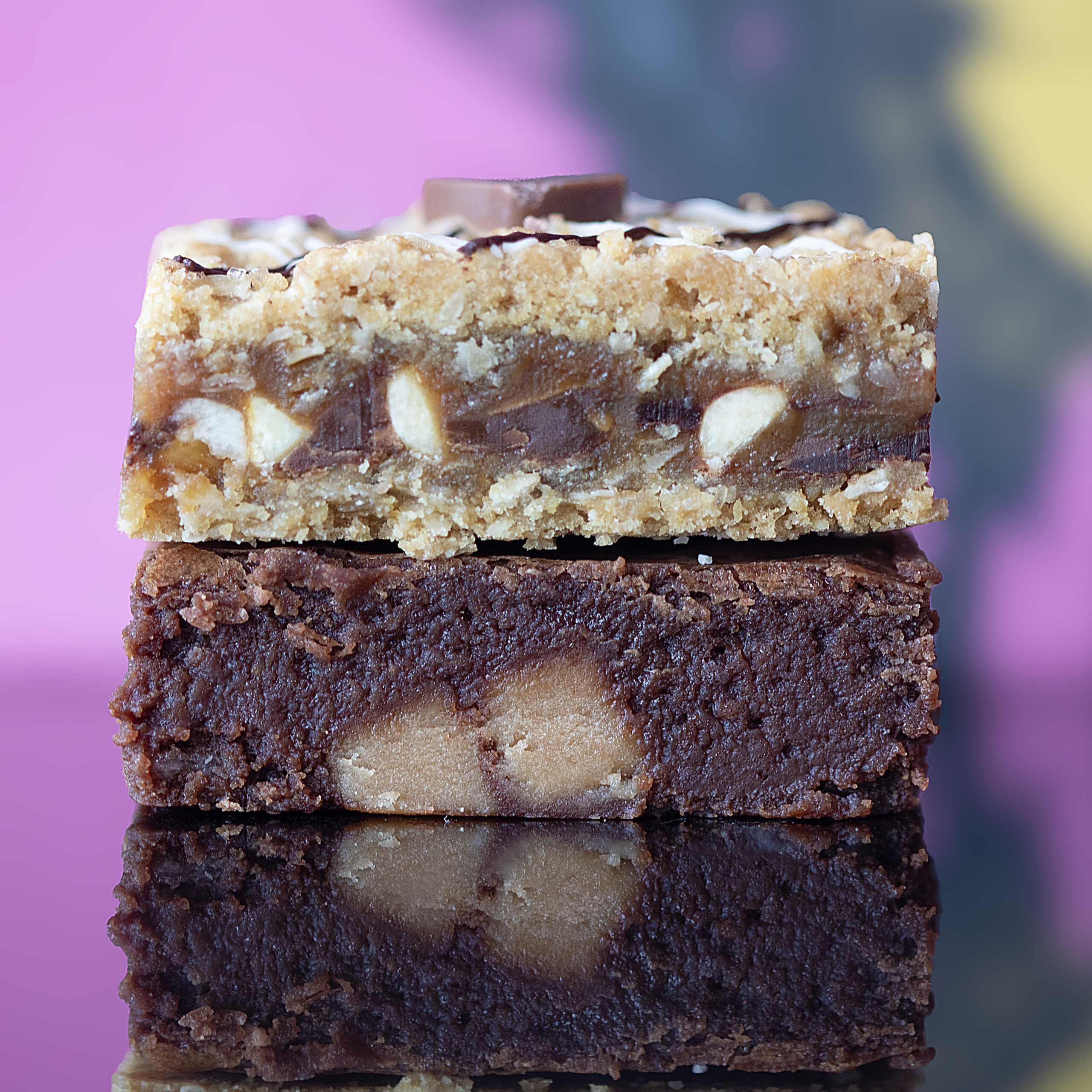 Stack of salted fudge brownies and triple chocolate crumbles